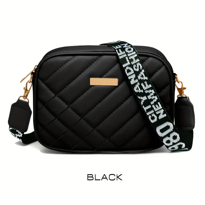 Black quilted handbag with a branded strap on a white background