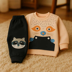 Children's sweatshirt and black pants with raccoon design on a beige carpet