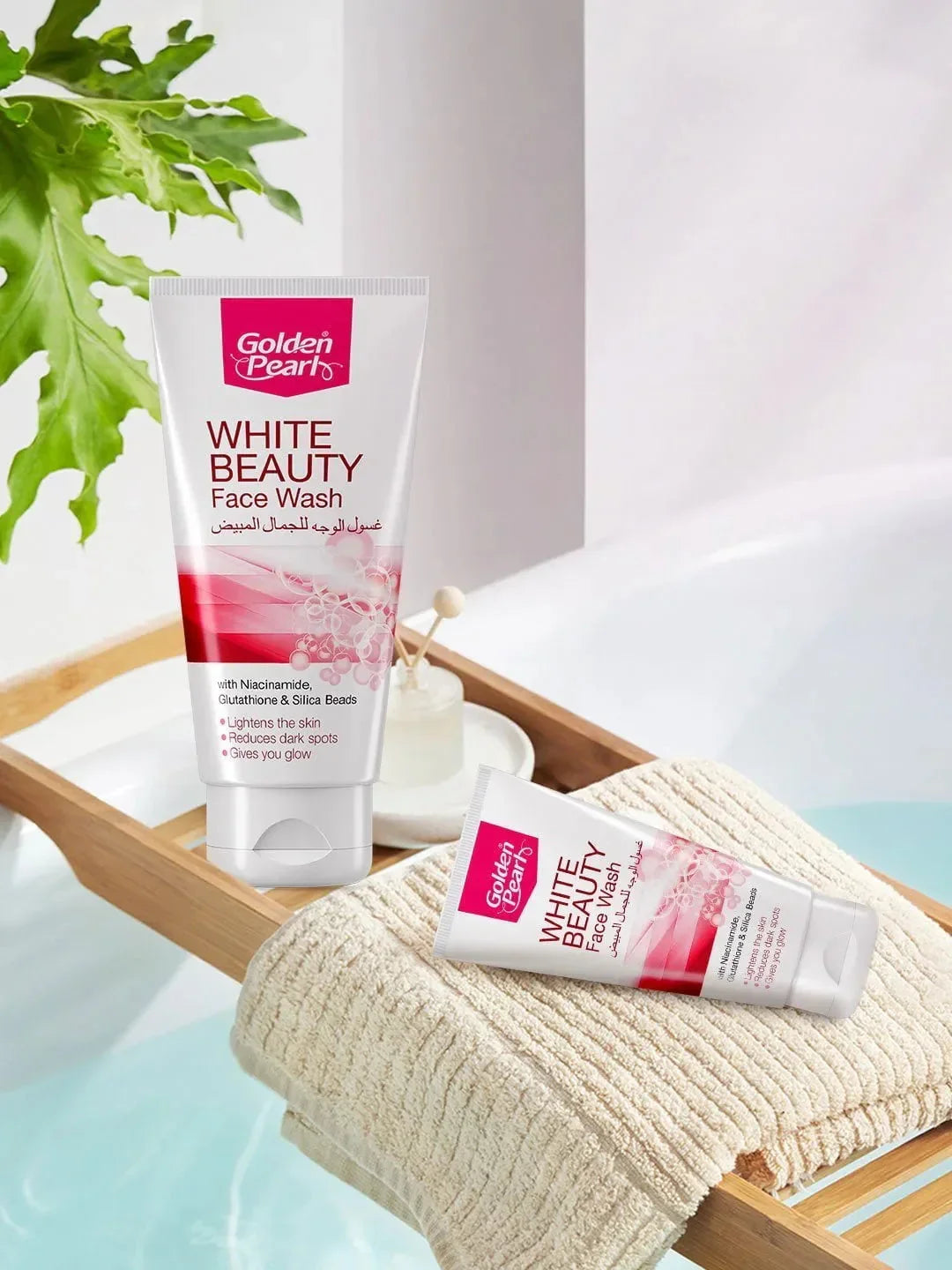 Golden Pearl White Beauty Face Wash on a towel with a plant in the background