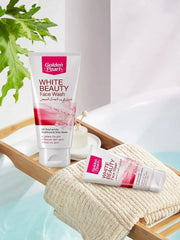 Golden Pearl White Beauty Face Wash on a towel with a plant in the background