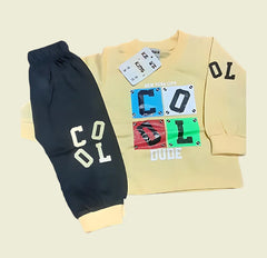 Yellow sweatshirt with colorful graphics and black pants on a beige background